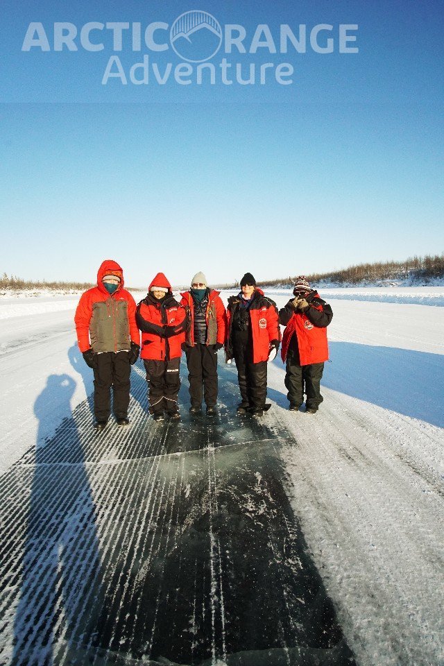 Group standing on the Ice Road to Aklavik Arctic Range Adventure